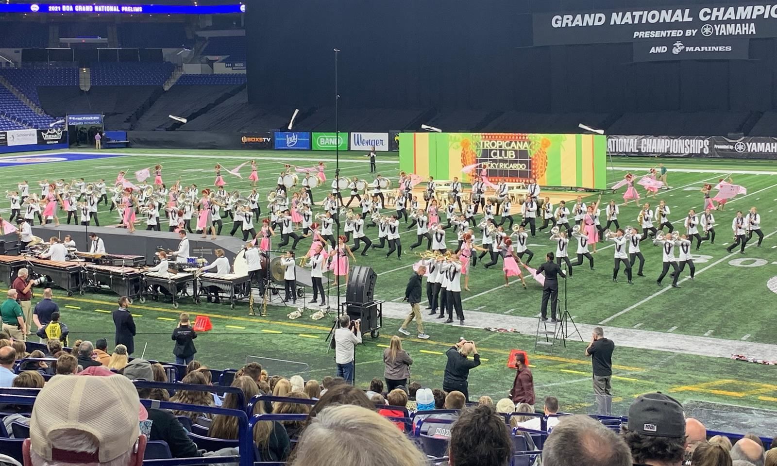 A marching band performs on a football field